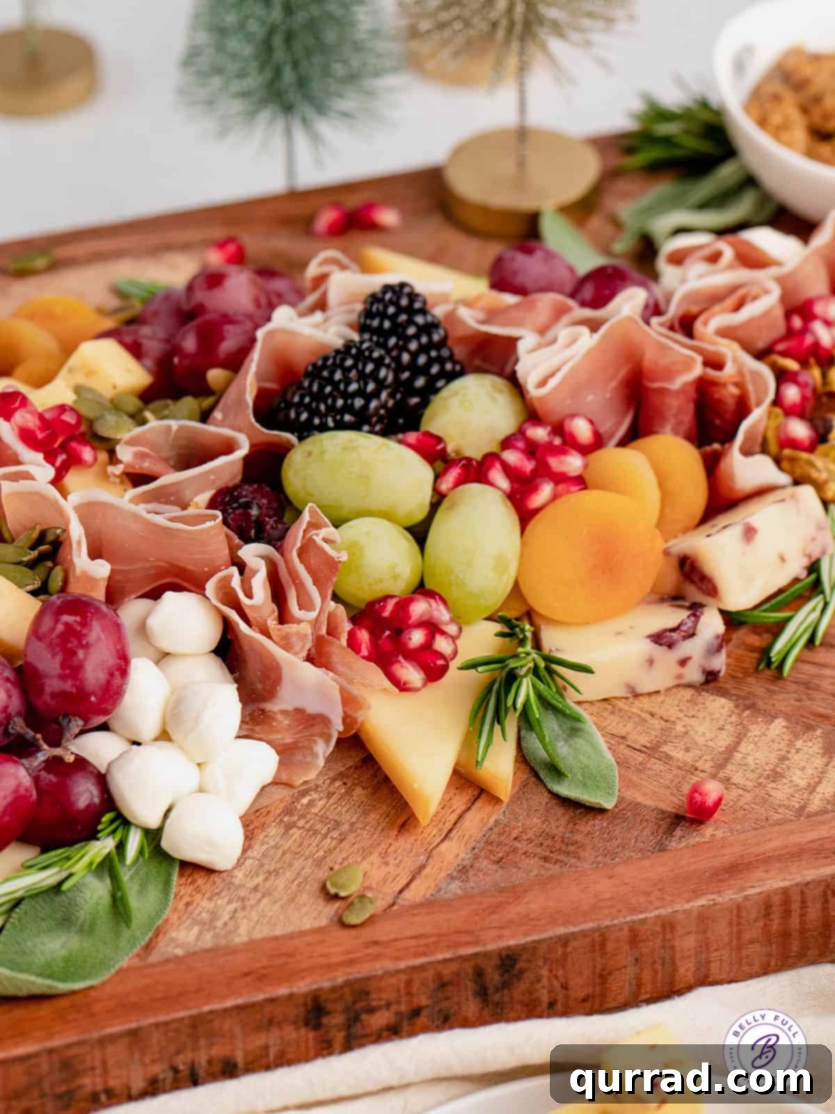 An artfully composed close-up of a Christmas Tree Charcuterie Board, highlighting the vibrant colors and appealing textures of its gourmet ingredients. A close-up view of a beautifully arranged festive holiday charcuterie board, showcasing an intricate pattern of cheeses, meats, fruits, and nuts.