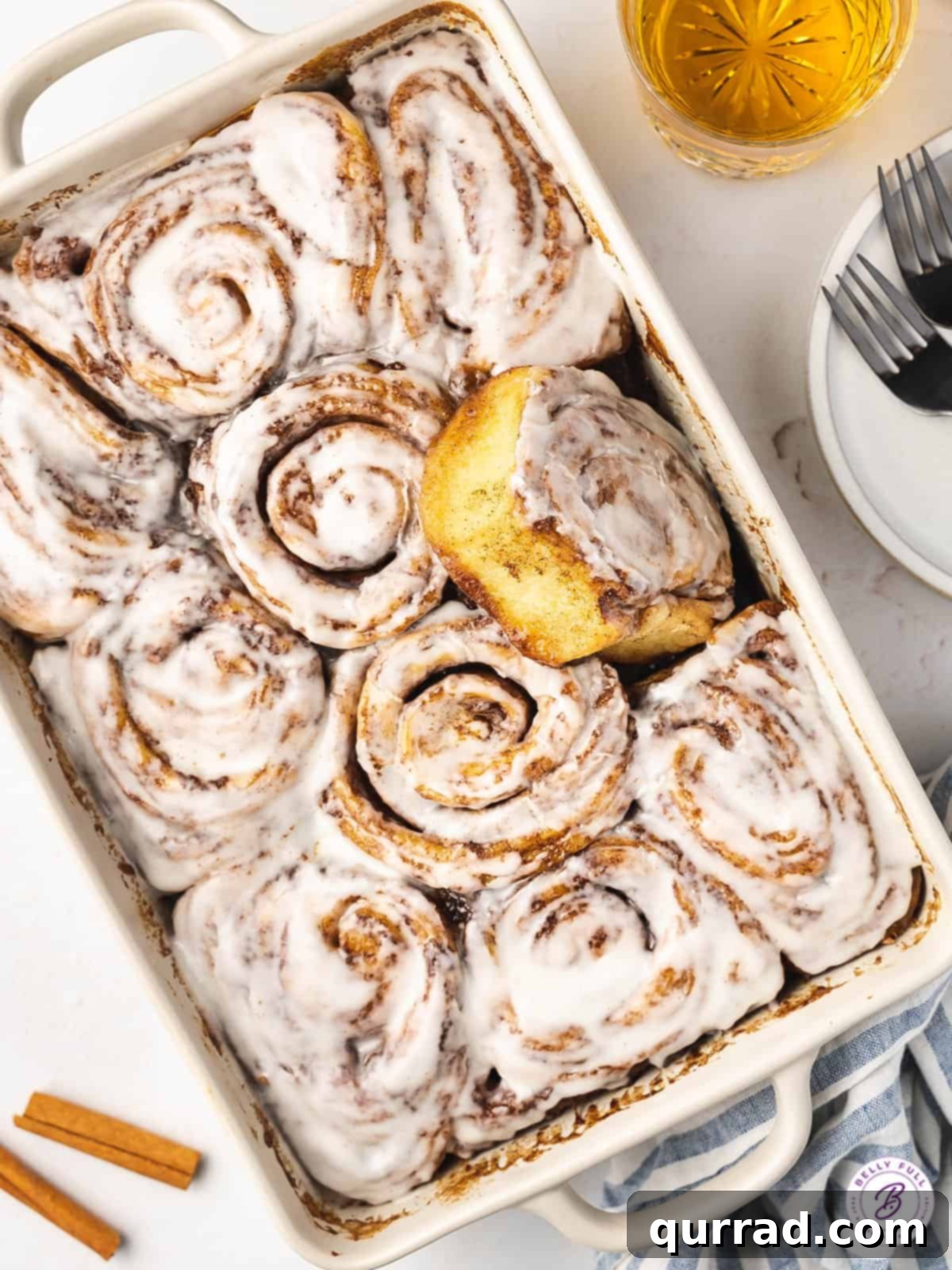 Foolproof Cinnamon Rolls 2 Overhead view of a baking dish of cinnamon rolls, glistening with icing