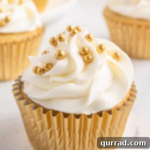 A prosecco cupcake in a gold cupcake wrapper