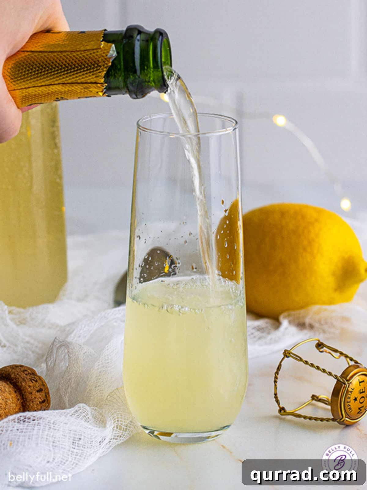 Made with gin, lemon juice, simple syrup, and champagne, this French 75 cocktail is easy to make and even easier to drink! Champagne being poured into a glass