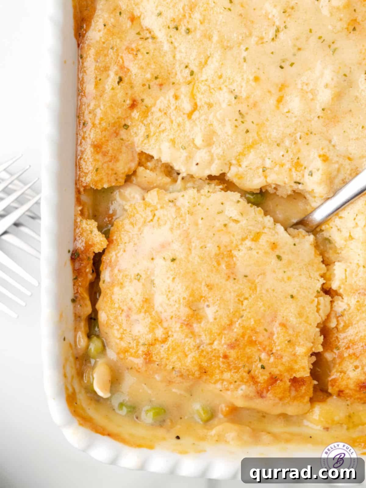 Chicken & Biscuit Pot Pie 3 biscuit chicken casserole being scooped with serving spoon