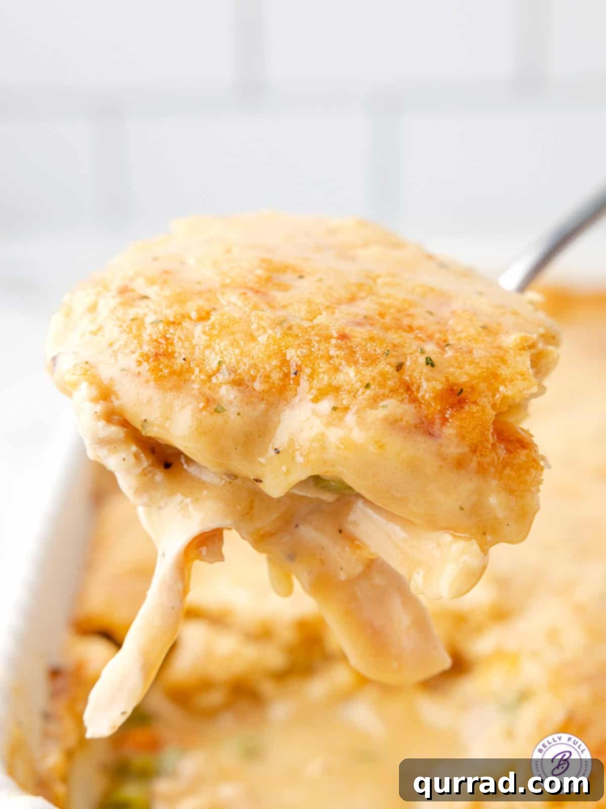 Chicken & Biscuit Pot Pie 4 portion of chicken pot pie on serving spoon