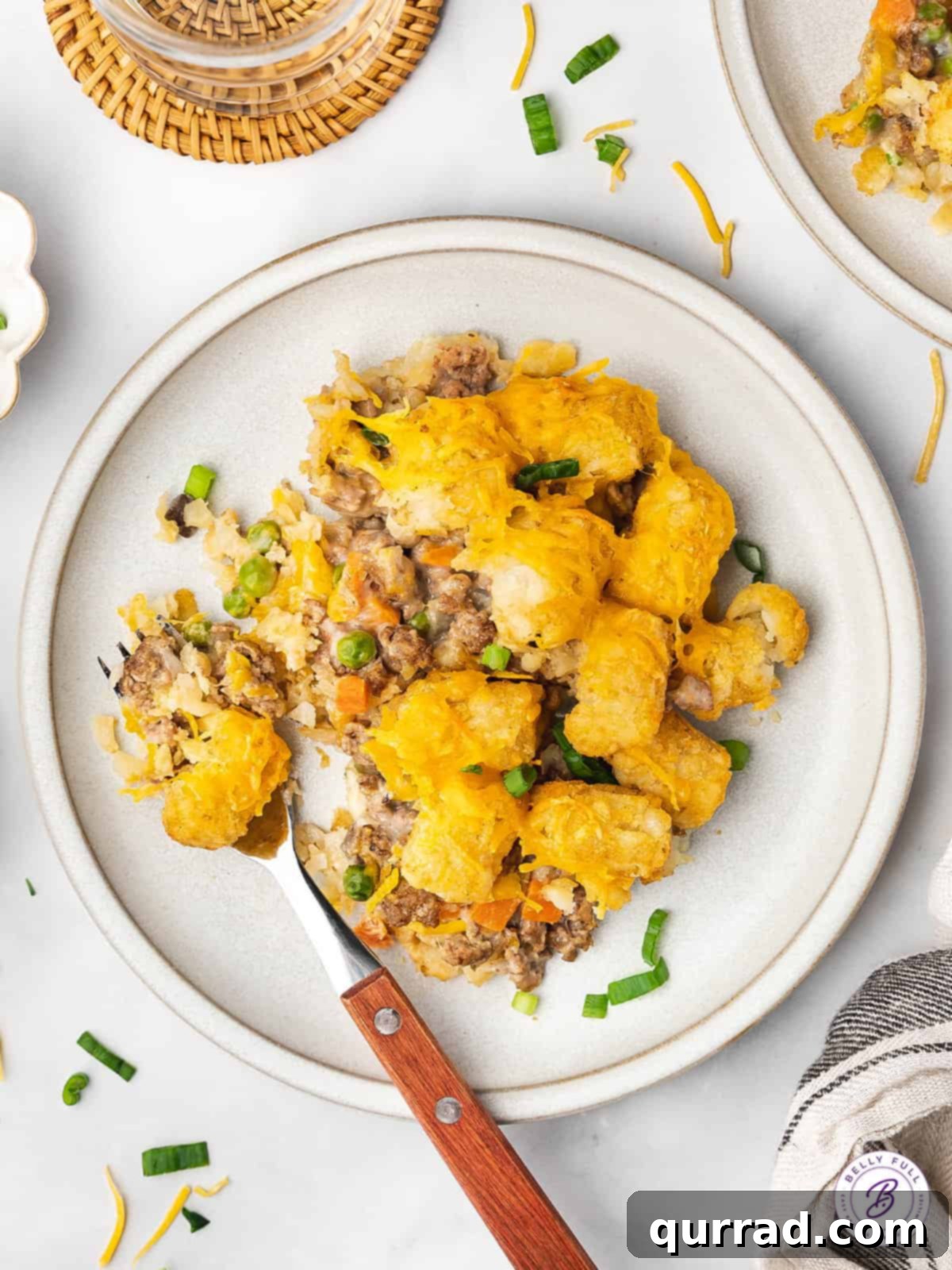 Made with ground beef, tater tots, cheese, frozen veggies, and soup, this Cheeseburger Tater Tot Casserole makes a quick and easy dinner. Overhead view of a delicious plate of cheeseburger tater tot casserole, ready to be enjoyed.