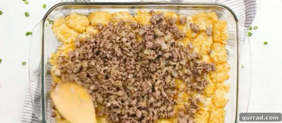 Golden Cheeseburger Tater Tot Bake 6 Layering the cooked beef, creamy soup mixture, and remaining tater tots in the baking dish.