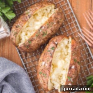 Crispy Air Fryer Baked Potatoes 2 Two baked potatoes on a cooling rack