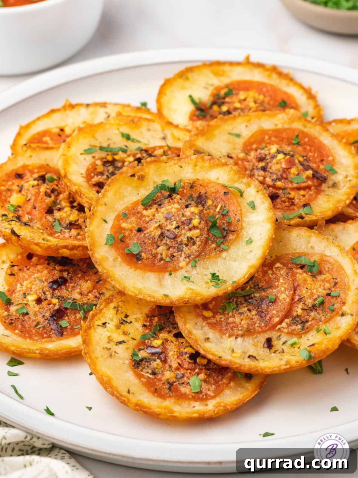Savor the taste of pizza without the carbs with these amazing Mozzarella Pizza Chips. Angled overhead view of mozzarella pizza chips ready to be served