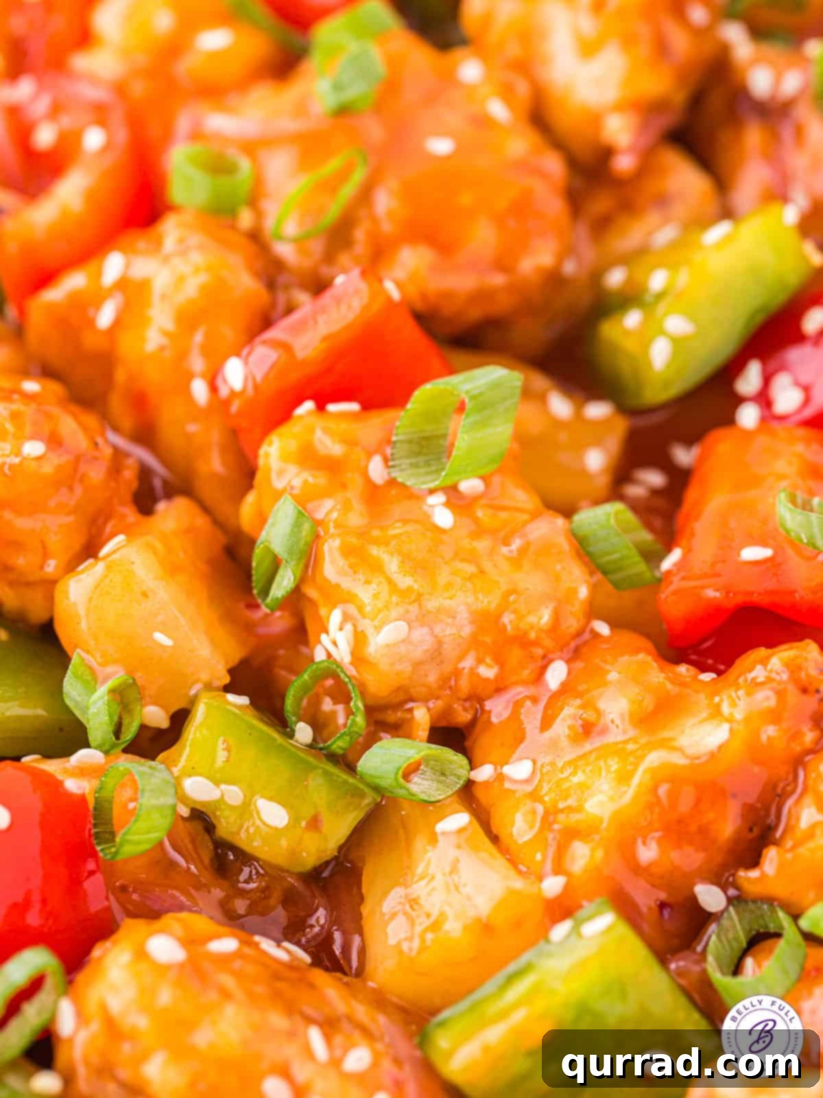 This easy homemade Sweet and Sour Pork recipe is a fantastic substitute for your favorite Chinese restaurant takeout. Sweet, sour, & savory! Close up of sweet and sour pork with pineapple