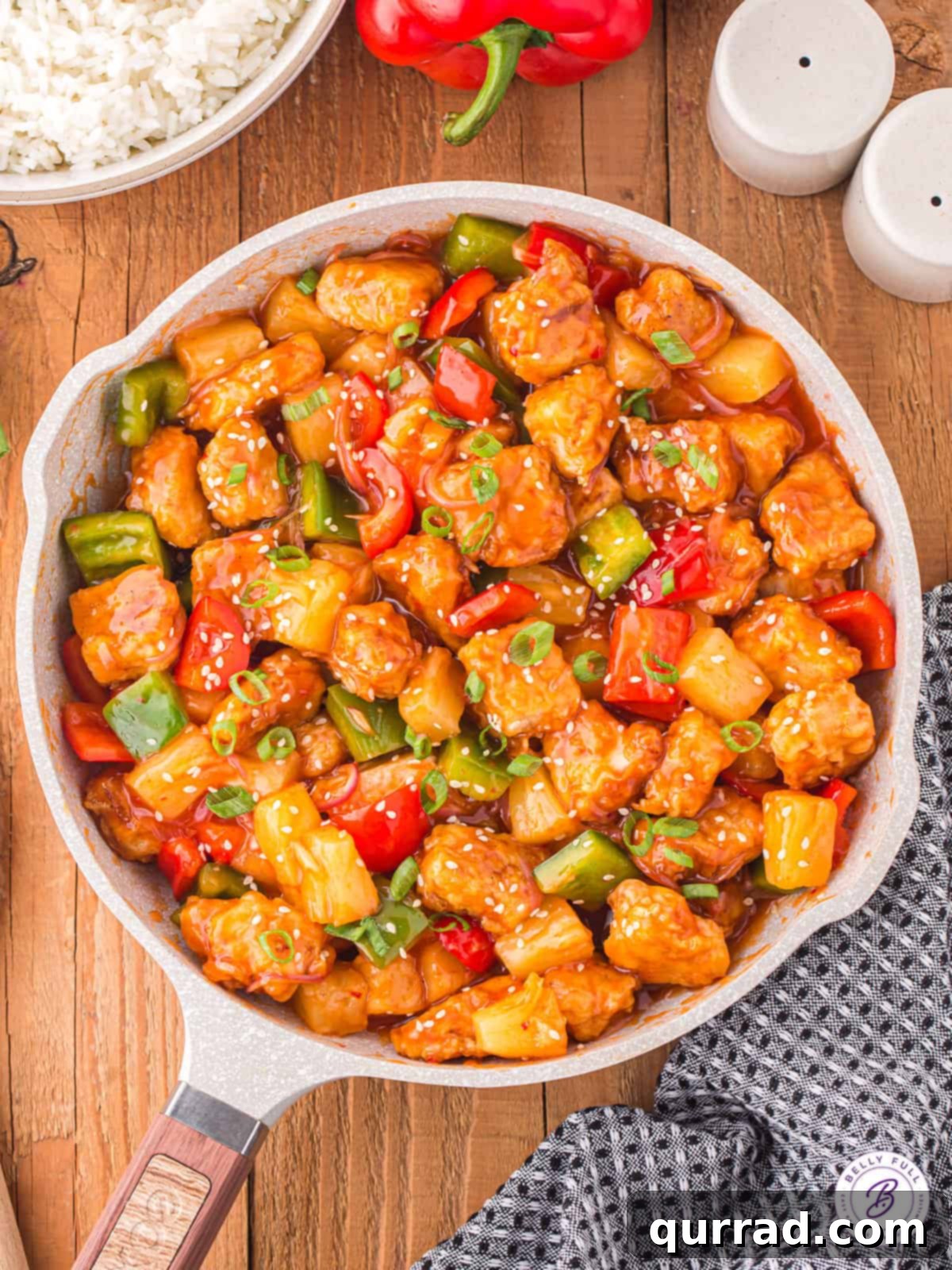This easy homemade Sweet and Sour Pork recipe is a fantastic substitute for your favorite Chinese restaurant takeout. Sweet, sour, & savory! Overhead view of a bowl of sweet and sour pork