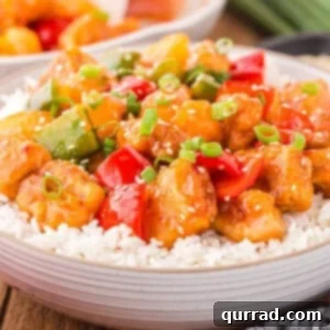 Golden Glazed Pork 2 Angled view of sweet and sour pork over rice