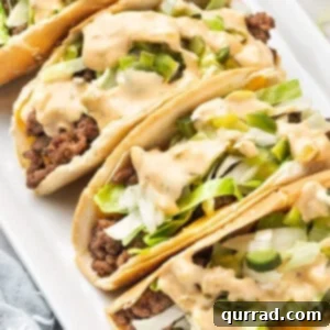 Big Mac Tacos arranged on a white plate, showcasing vibrant toppings and special sauce.