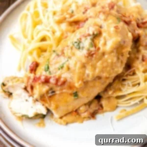 The Proposal-Perfect Chicken 2 Overhead view of creamy sundried tomato chicken on a plate with pasta