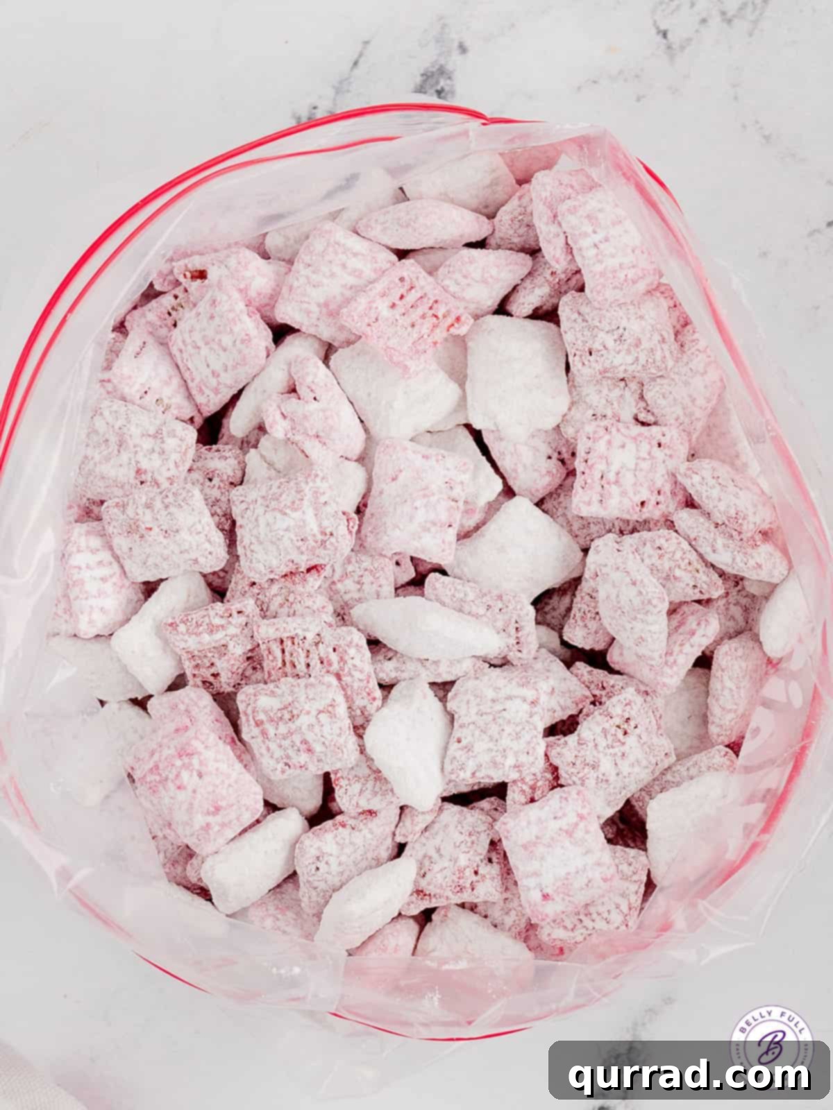 Red and white chocolate-coated Chex cereal presented in a clear plastic bag, ready for gifting or snacking.