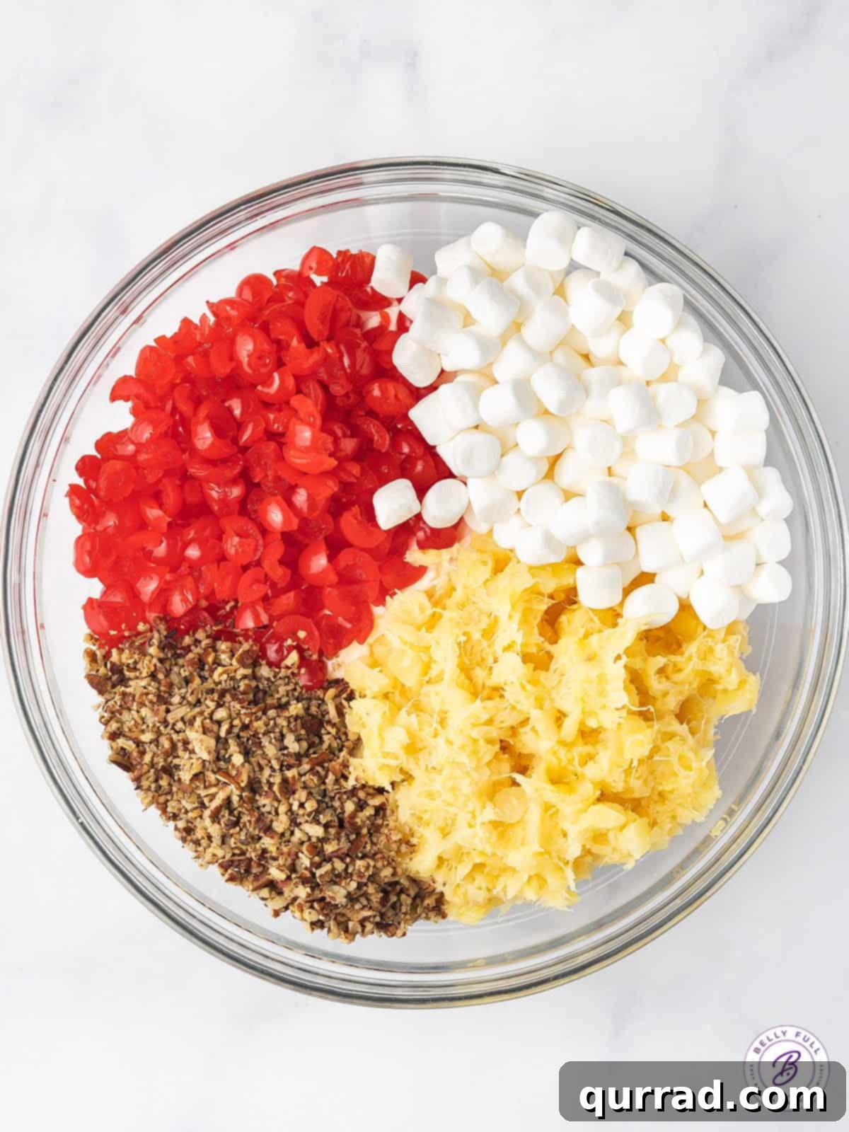 This Cherry Fluff is made with cream cheese, homemade whipped cream, maraschino cherries, and crushed pineapple for a quick and easy dessert. Cherry fluff ingredients in a bowl