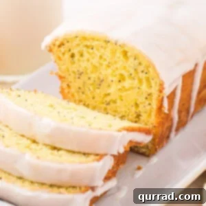 Lemon poppy seed loaf with three pieces sliced off