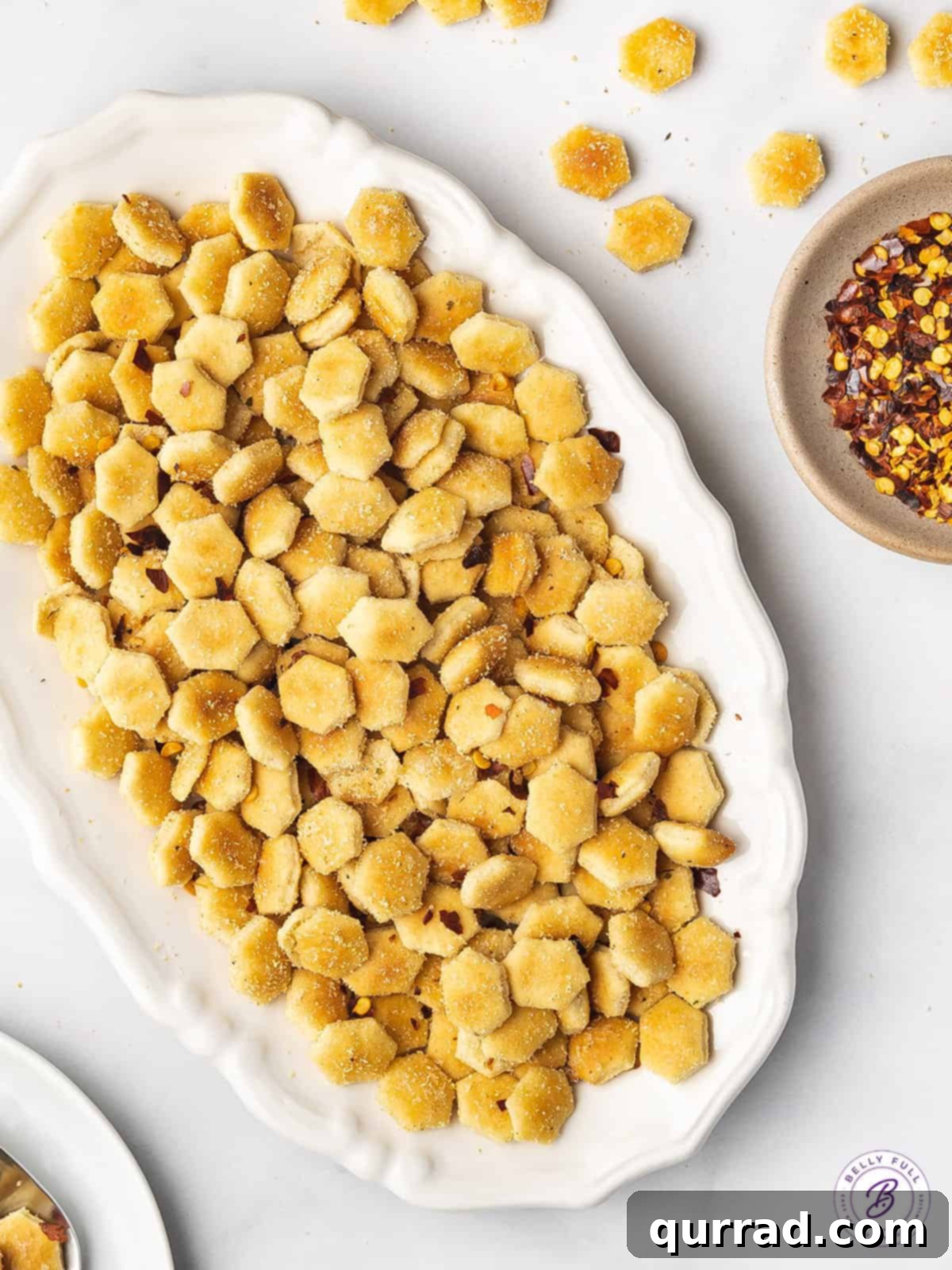 A Symphony of Sparks 3 Overhead view of perfectly seasoned fire oyster crackers on a clean white plate, ready for snacking
