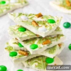Stack of St. Patrick's Day white chocolate bark with pretzels and green M&Ms
