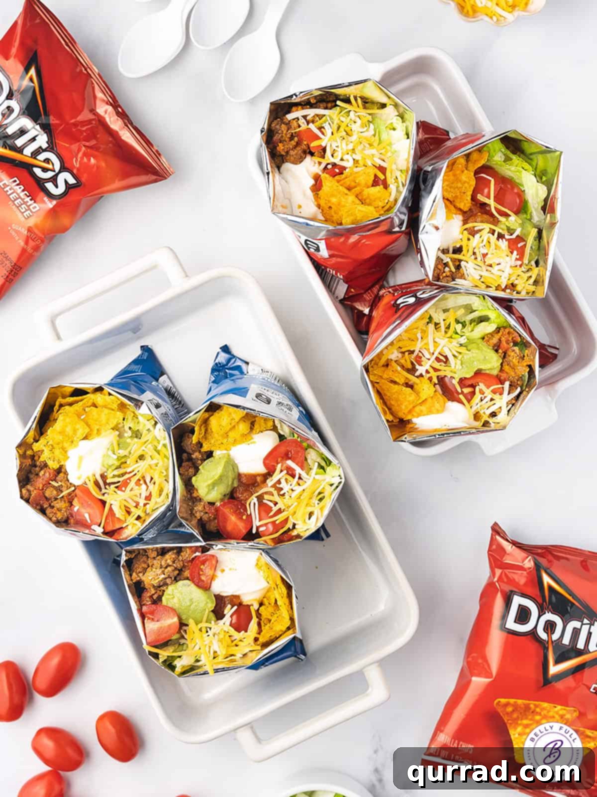Walking Tacos feature all of your favorite taco ingredients and toppings in a personal-sized bag of chips. Quick and easy to prepare! Overhead view of walking tacos in a baking dish