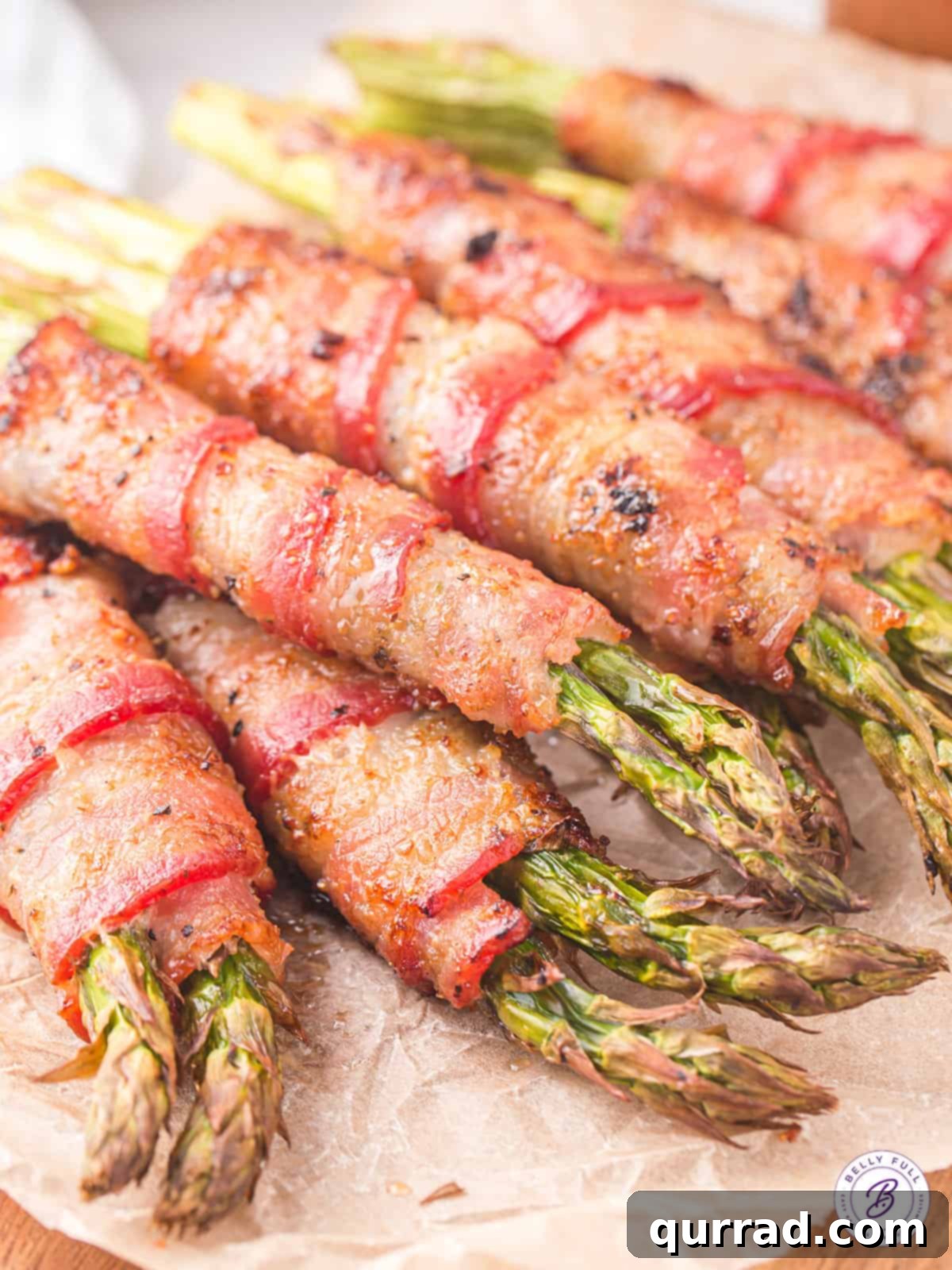 Crispy Air Fryer Bacon Wrapped Asparagus: A Quick & Flavorful Side Close up of perfectly cooked bundles of bacon wrapped asparagus, golden brown and crispy