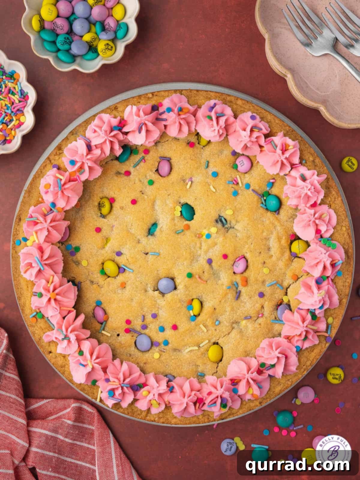 Overhead view of an Easter cookie cake with pink frosting and sprinkles, showing its festive design.