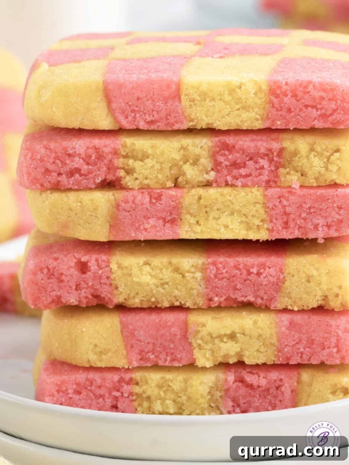 These fun Checkerboard Icebox Cookies are perfect for springtime or Easter and look so impressive on a buffet table. A neatly stacked pile of colorful checkerboard icebox cookies, showcasing their uniform shape and appealing two-tone pattern.