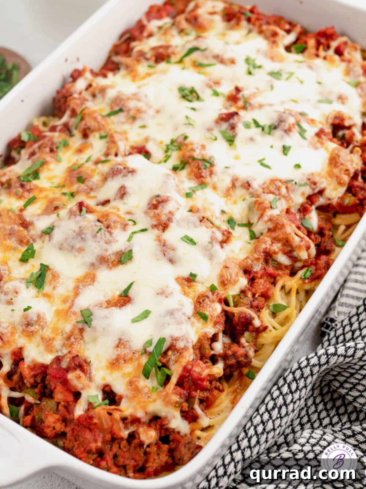 Made with spaghetti, marinara meat sauce, and homemade alfredo sauce, this Million Dollar Spaghetti Alfredo is an easy weeknight dinner. Overhead view of million dollar spaghetti casserole, baked to golden perfection with bubbly cheese