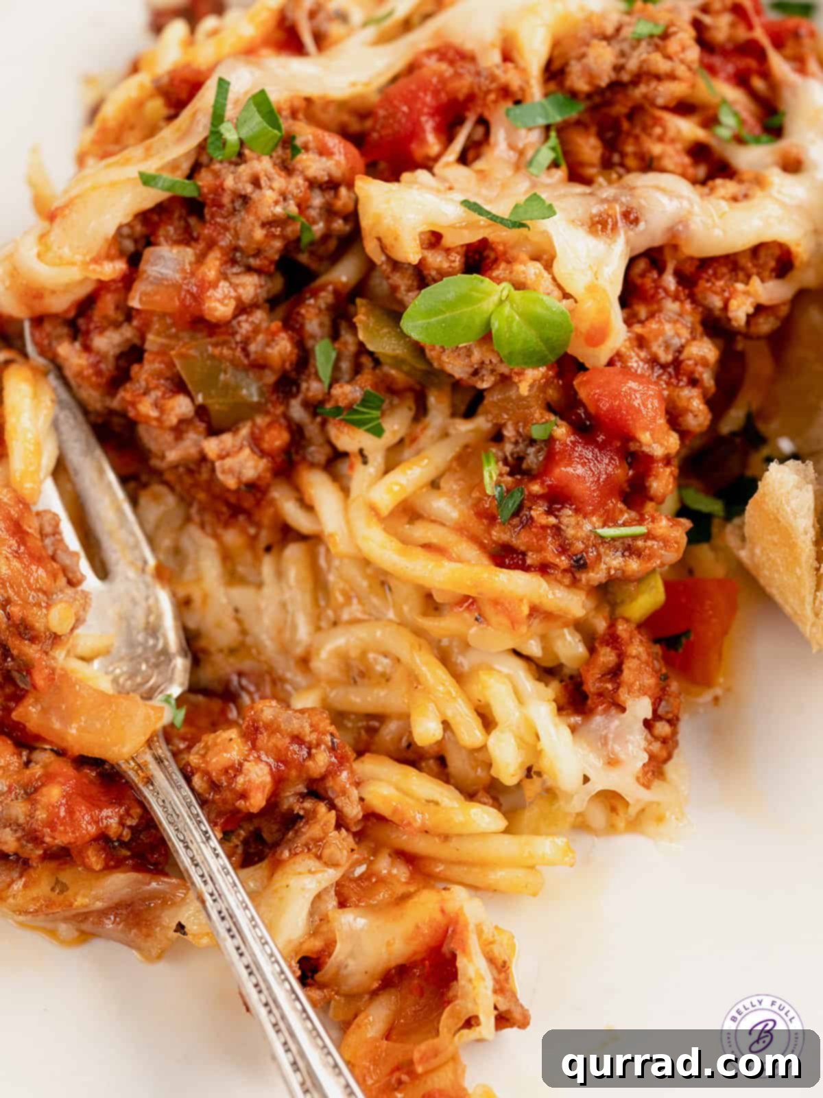 Made with spaghetti, marinara meat sauce, and homemade alfredo sauce, this Million Dollar Spaghetti Alfredo is an easy weeknight dinner. Million dollar spaghetti on a plate with a fork, ready to be eaten