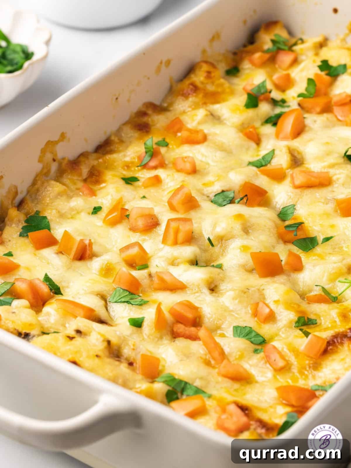 Made with biscuits, chicken breast, and homemade alfredo sauce, this Chicken Alfredo Bubble Pizza makes a quick and easy weeknight dinner. Overhead view of chicken alfredo bubble pizza in a casserole dish