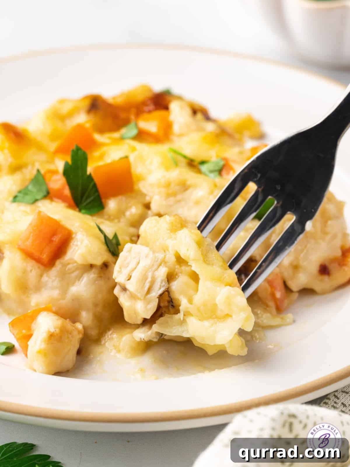 Made with biscuits, chicken breast, and homemade alfredo sauce, this Chicken Alfredo Bubble Pizza makes a quick and easy weeknight dinner. A slice of chicken alfredo bubble up pizza with a fork in it