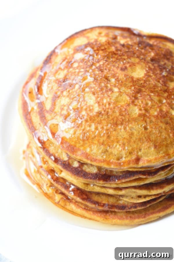 Harvest Pumpkin Griddlecakes 3 stack of pumpkin pancakes with honey and whipped cream