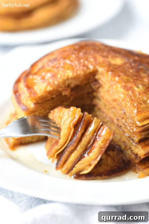 Harvest Pumpkin Griddlecakes 4 bite of pumpkin pancakes on fork with syrup