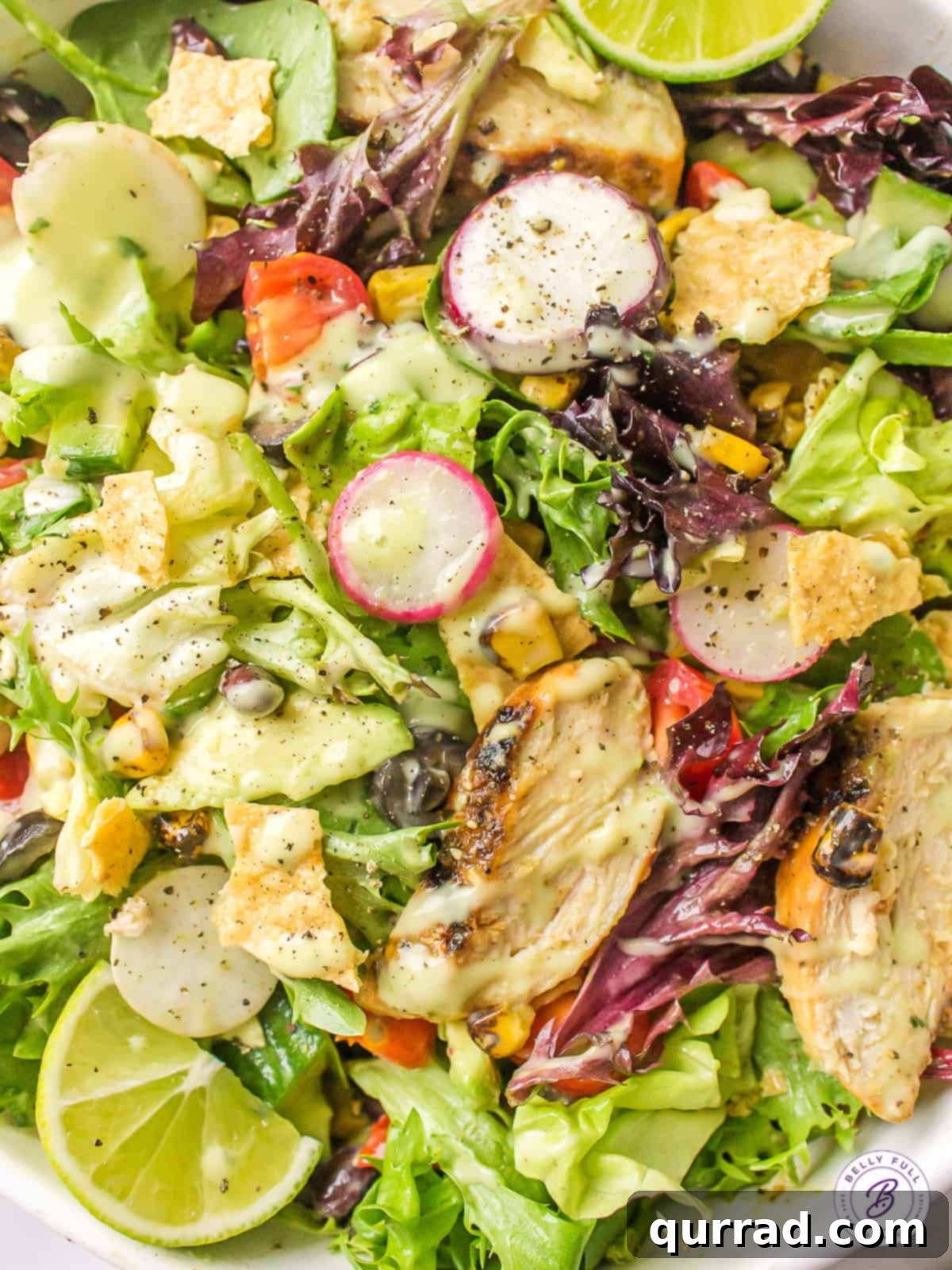 With well-seasoned grilled chicken, grilled corn, black olives, and tomatoes, this Southwest Chicken Salad is bursting with color and flavor. Overhead view of southwest chicken salad