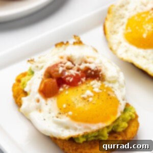 Hash brown avocado toast with a perfectly cooked egg and fresh salsa