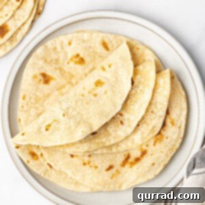 Folded flour tortillas on a plate