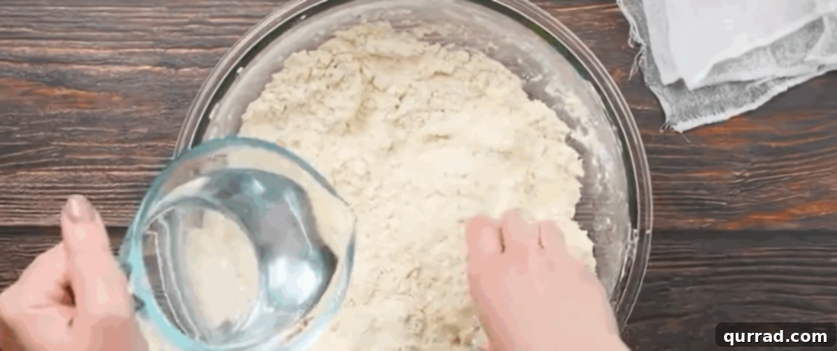 Pouring hot water into the flour and lard mixture, slowly forming a dough for tortillas.