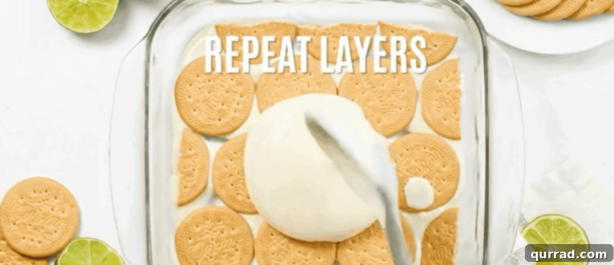 Lemon Icebox Cake 5 Layers of Maria cookies and creamy lime filling being assembled in a square baking dish for Carlota de Limón.