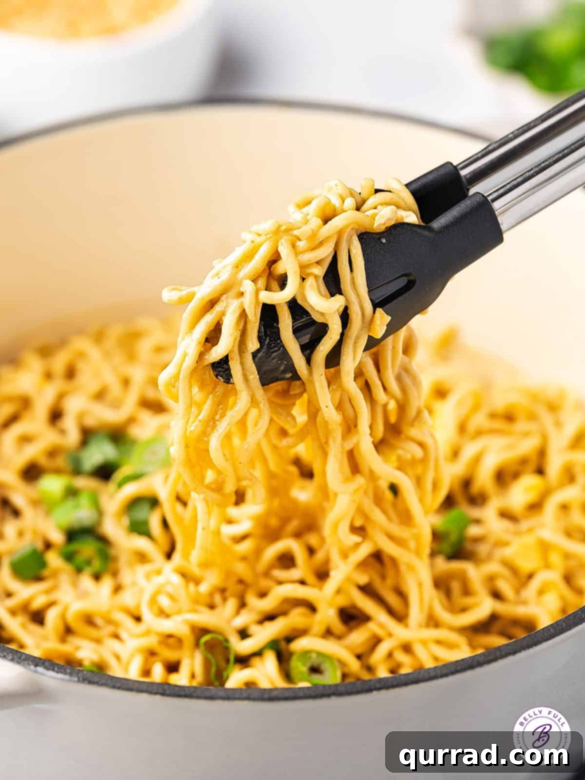 Ramen Pad Thai features inexpensive ramen noodles coated in a simple but flavor-packed peanut sauce. Ready in 10 minutes! Tongs serving easy pad Thai