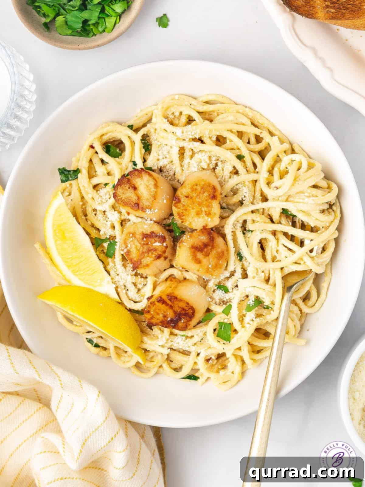 Overhead view of a bowl of seared scallop piccata
