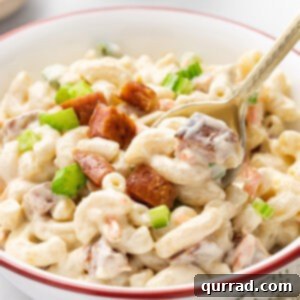 A spoon stirring macaroni Hawaiian salad