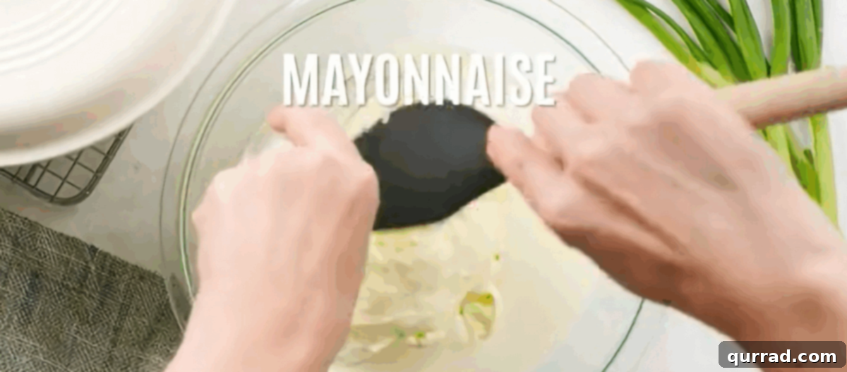 Aloha Macaroni Salad 4 Whisking together whole milk, heavy cream, mayonnaise, sugar, pepper, salt, garlic powder, and paprika for the rich and creamy dressing