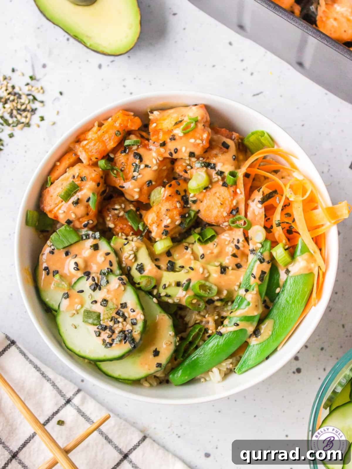 Air Fryer Salmon Bowls: Easy, Healthy, and Flavorful Overhead view of a vibrant salmon rice bowl featuring perfectly cooked salmon, fresh cucumber, and crisp carrots