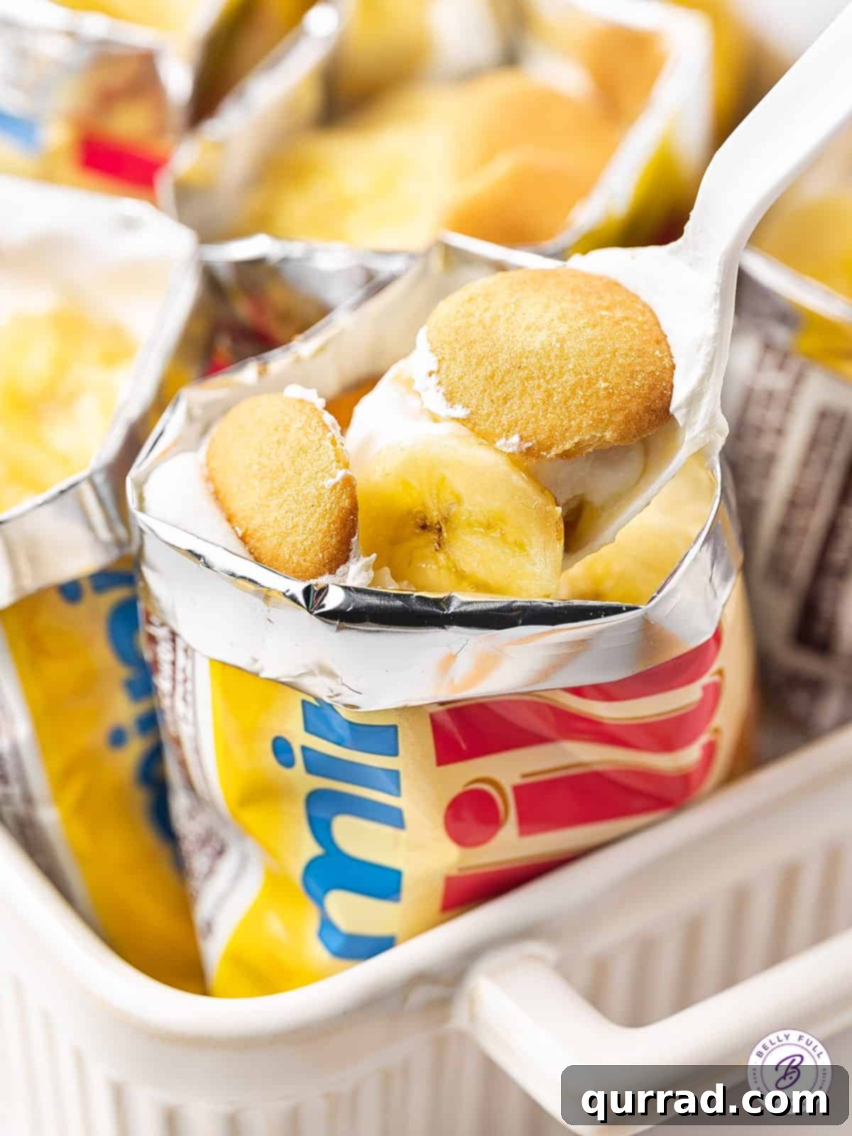An individual serving of creamy Walking Banana Pudding in a Nilla wafer bag, ready to be enjoyed as a portable summer dessert.