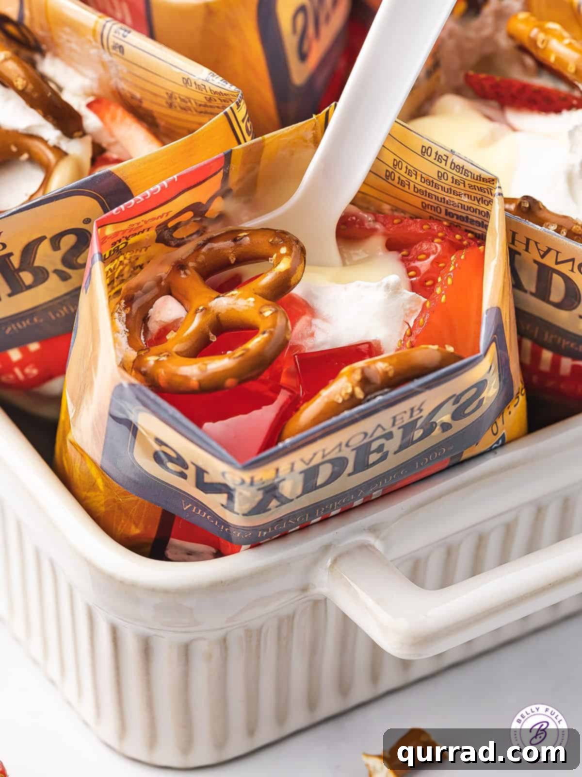 A spoon in an individual strawberry pretzel salad