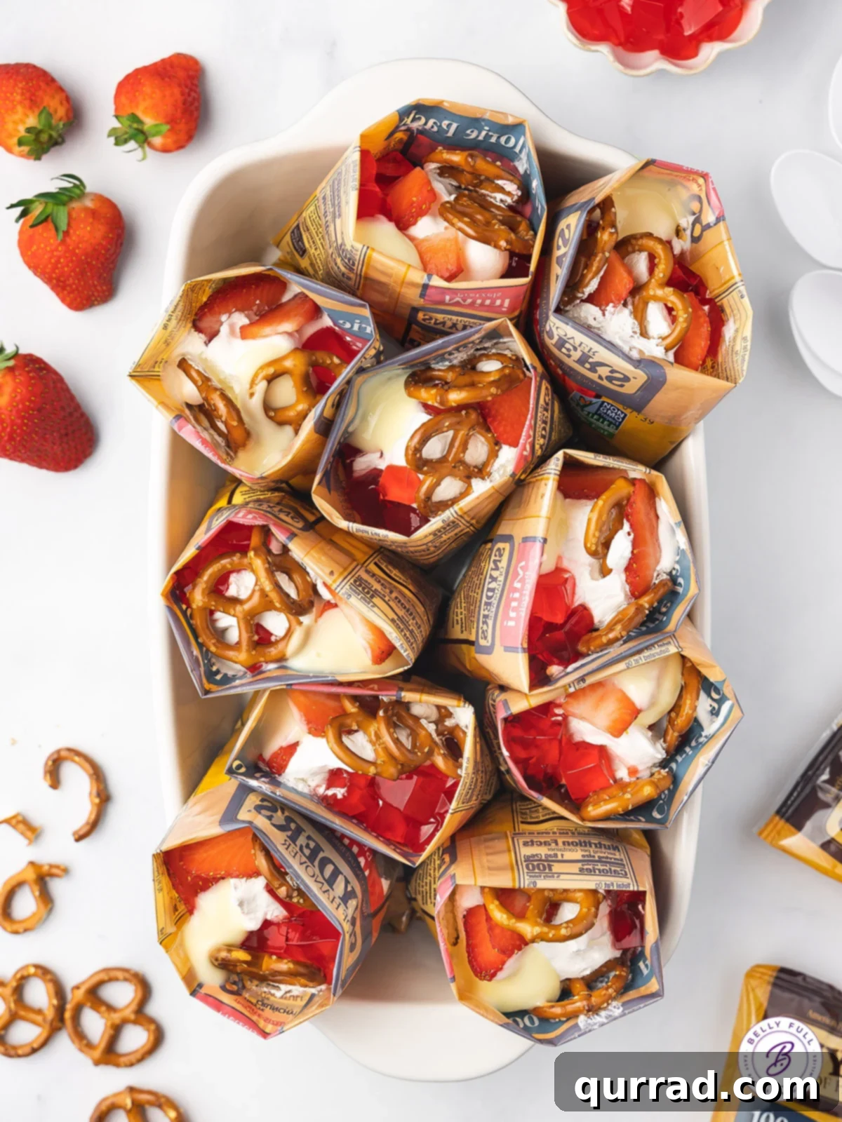Overhead view of bags of walking strawberry pretzel salad standing up in a baking dish