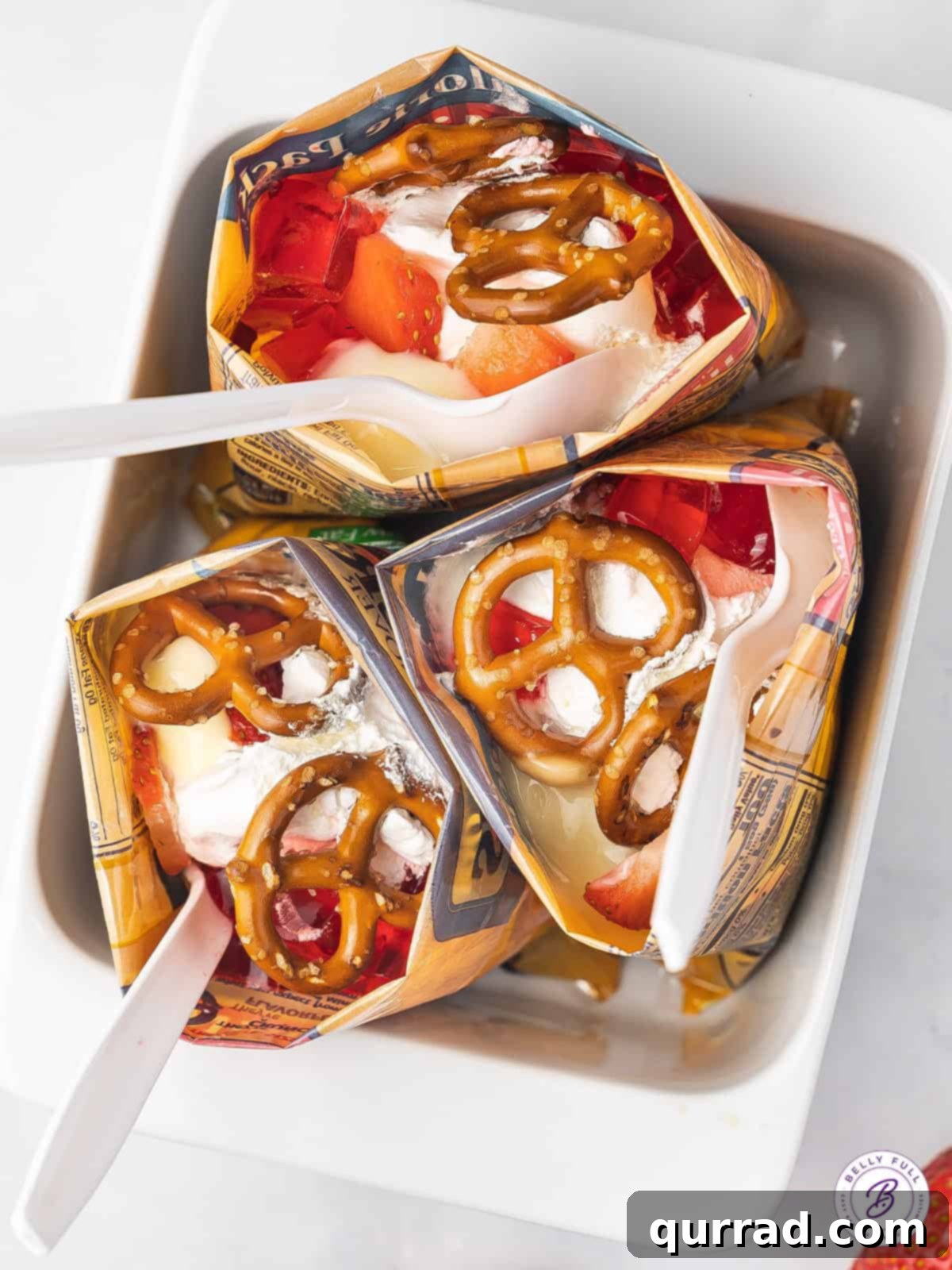 Overhead view of walking strawberry pretzel salad standing up in a baking dish