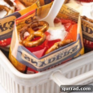 A spoon in an individual strawberry pretzel salad