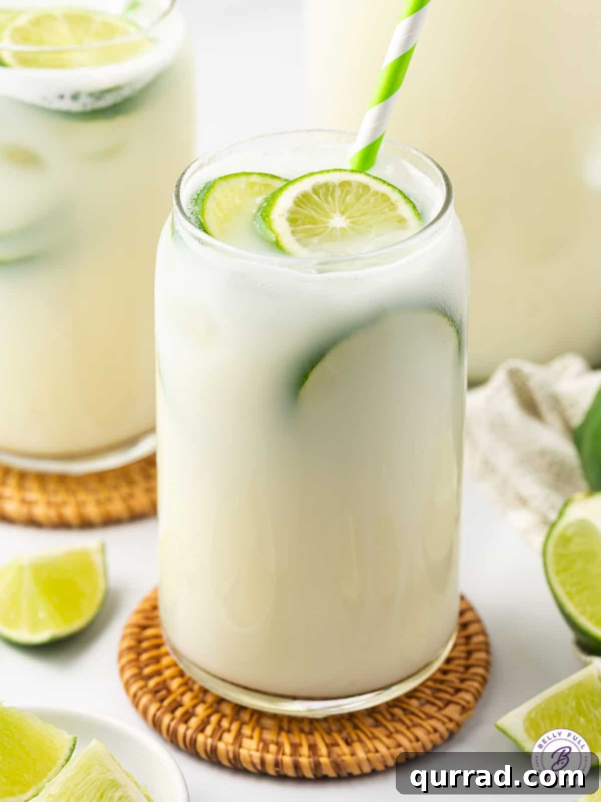 Experience the rich, luscious, and super refreshing taste of Brazilian Lemonade, crafted with fresh lime juice, lime zest, and sweetened condensed milk. A glass of creamy Brazilian limeade garnished with a lime slice, ready to be enjoyed.