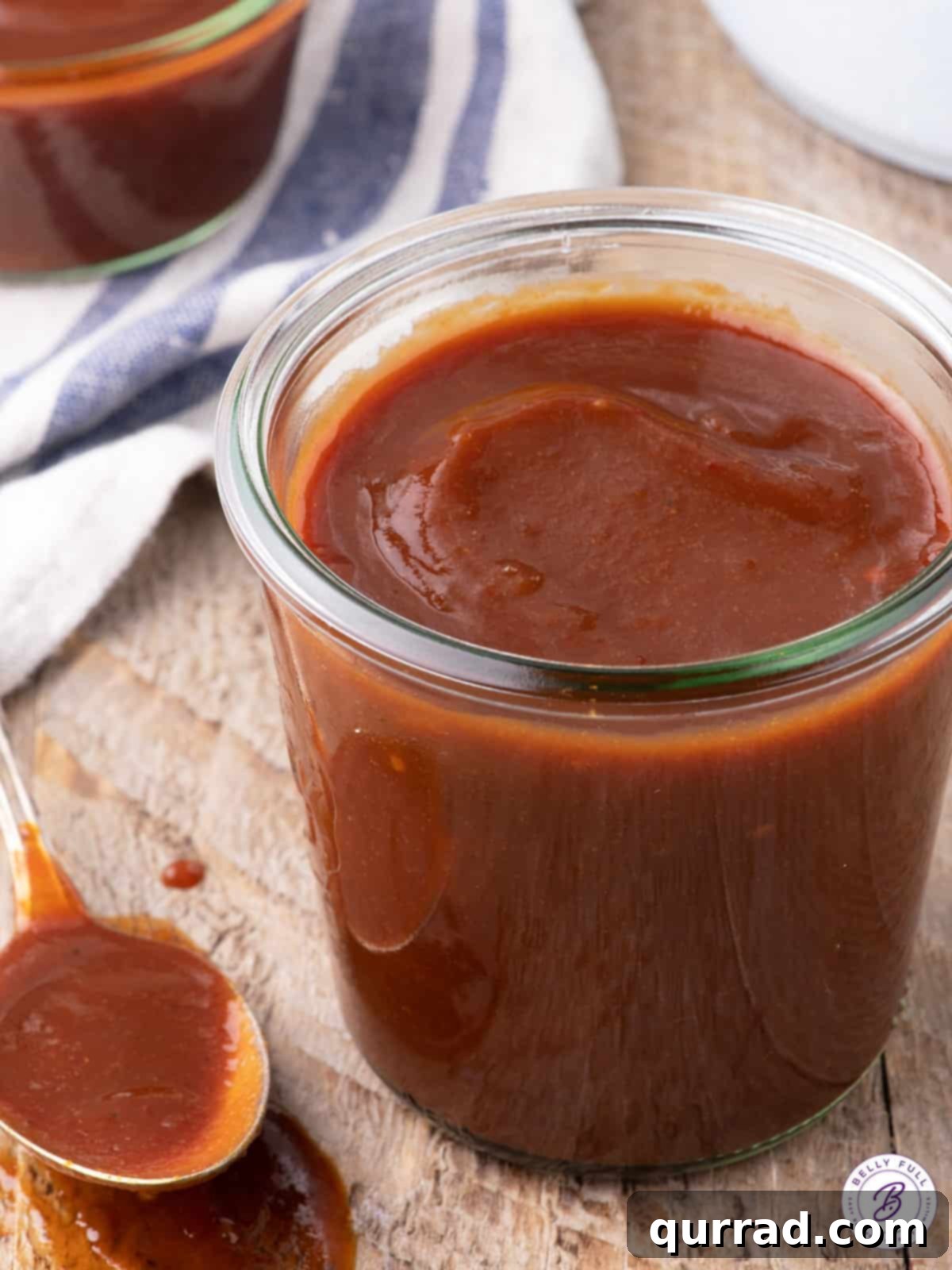 A beautifully presented jar of homemade bourbon BBQ sauce.