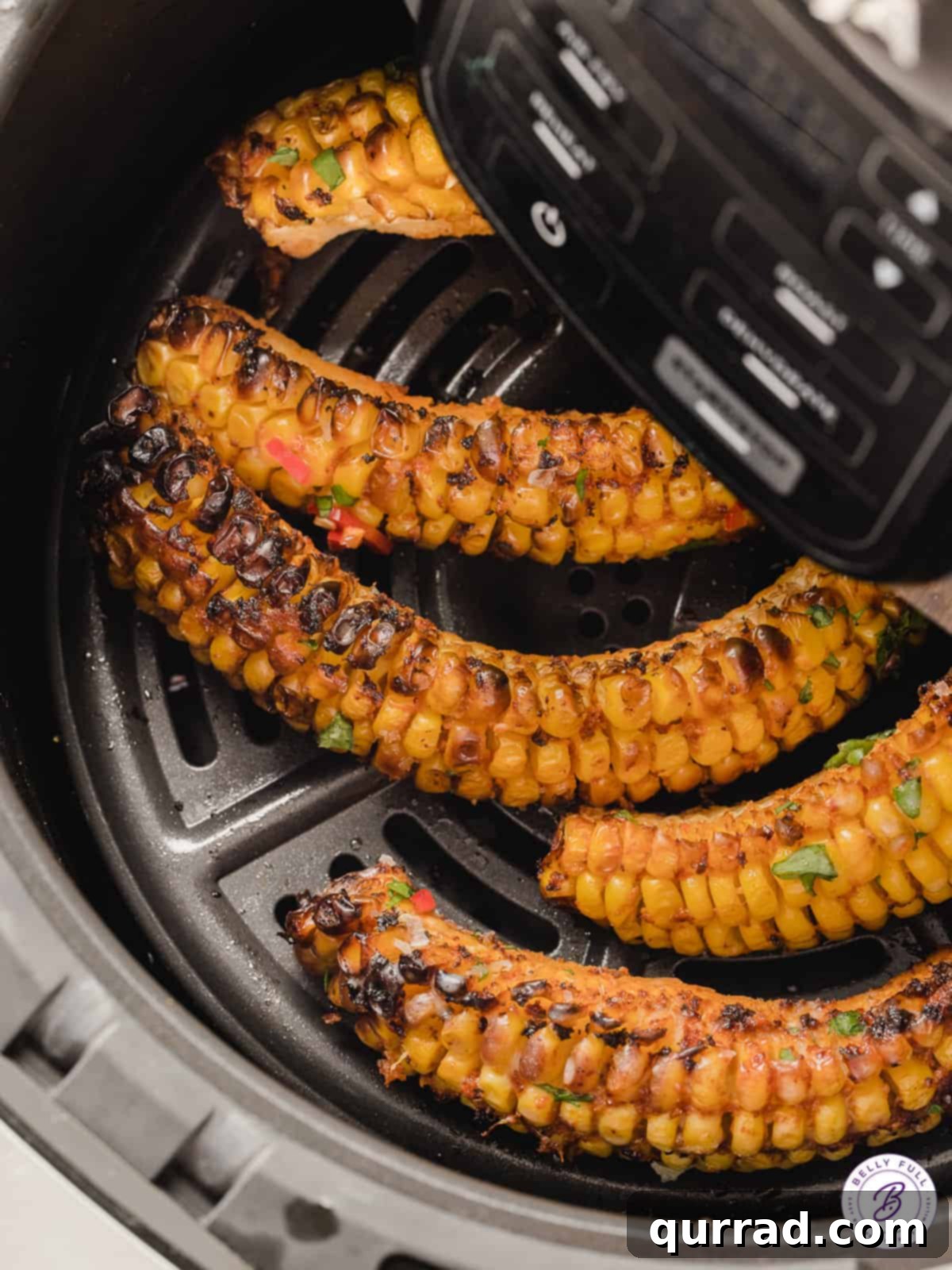 Addictive Air Fryer Corn Ribs 3 Overhead view of corn ribs cooking in an air fryer basket