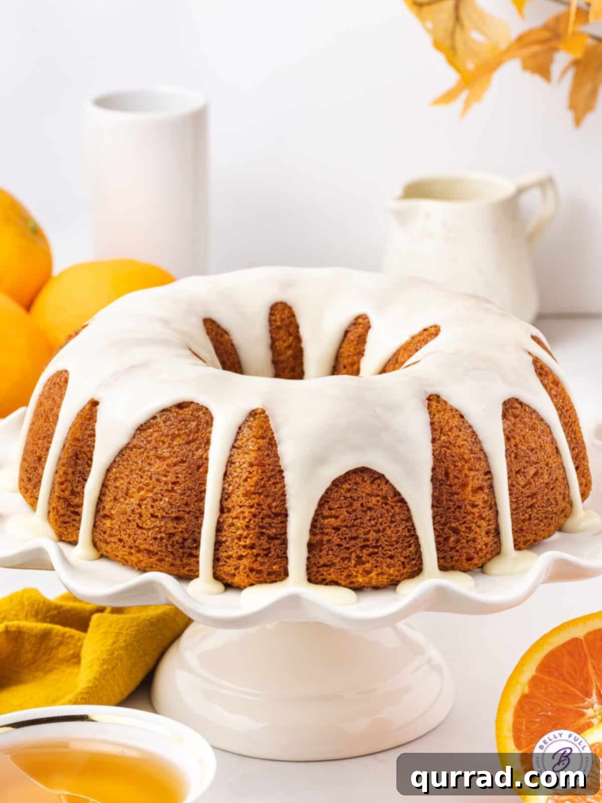 glazed bundt cake on white stand
