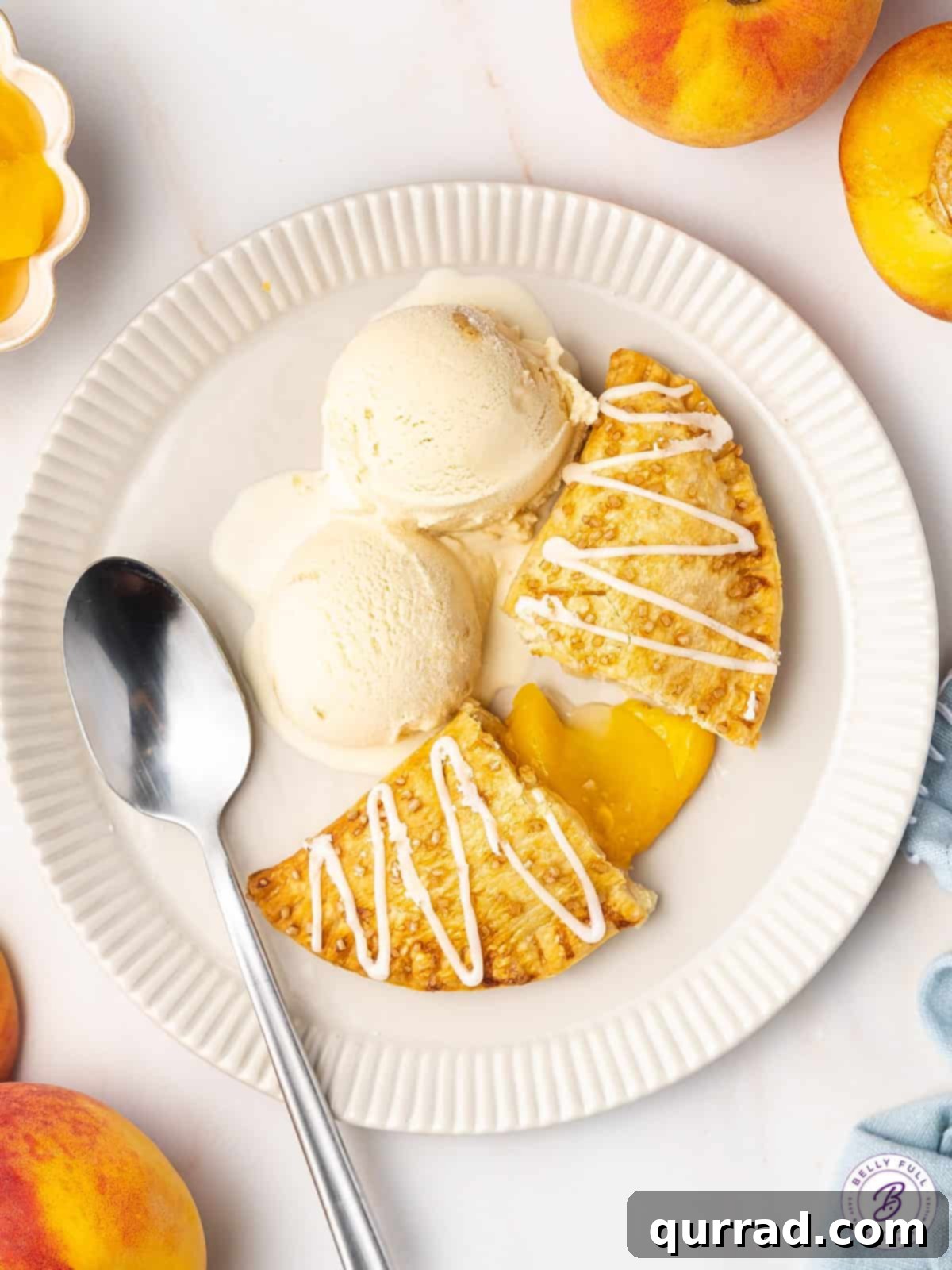peach hand pie split in half with vanilla ice cream